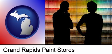 a couple looking at paint samples at a paint store in Grand Rapids, MI